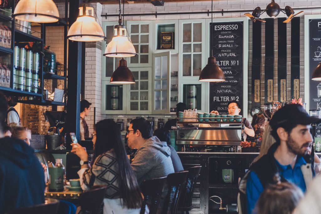 Side-shot of a people having a sumptuous meal at a local restaurant. The blog post is about hyperlocal social media marketing.