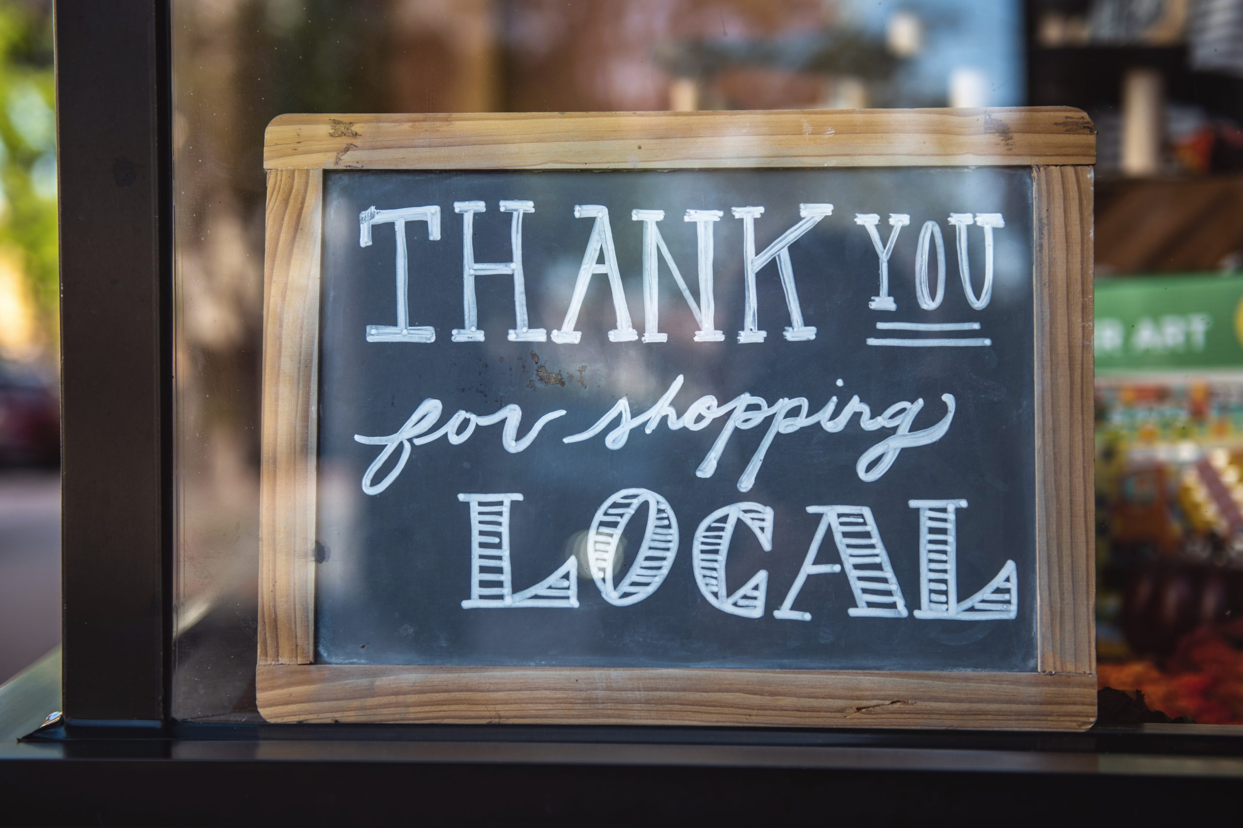 Chalkboard sign that says Thank you for Shopping Local. hyperlocal social media