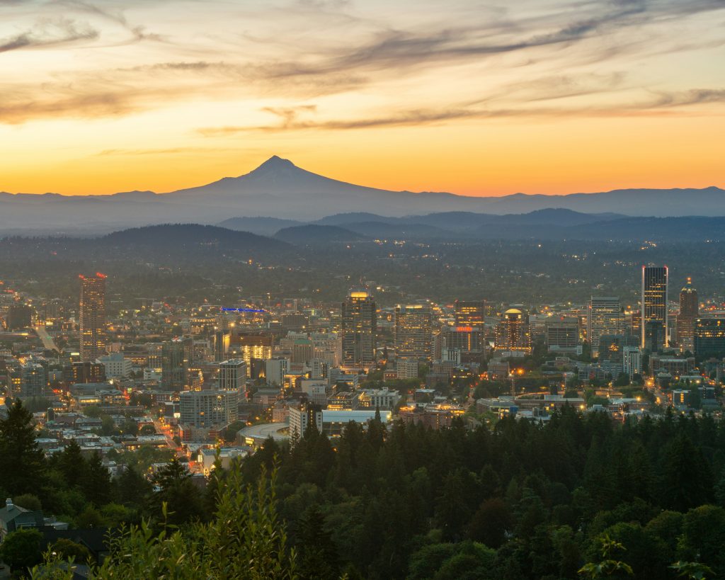 A social media manager in Portland looking that the sunset view of Portland city with Mount Hood in the backdrop.